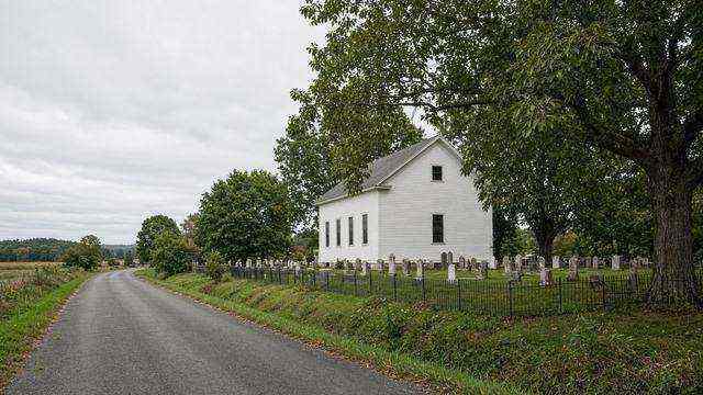 White country church and graveyard at Unionville, empty of a crowd